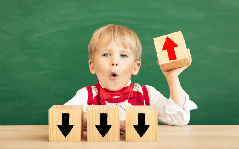 paid or organic marketing, boy with blocks pointing down and up